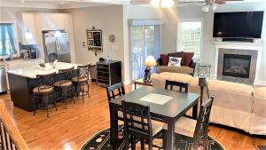 a living room with a couch and a table and chairs at Seamans Folly On Broad in Cape May