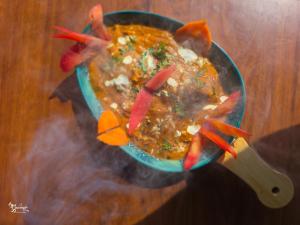 a bowl of food with peppers on a table at Miransh Heavenly in Dapoli