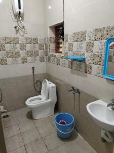 a bathroom with a toilet and a sink at HAnsHari Homestay in Kuttālam