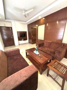 a living room with a couch and a coffee table at Tipsyy Heritage Heights in Jaipur
