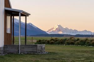 a building with a view of a snow covered mountain at Omahau Down in Lake Pukaki