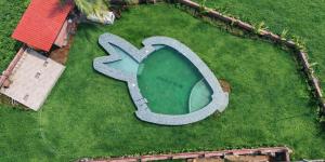 an overhead view of a swimming pool in a yard at Miransh Heavenly in Dapoli