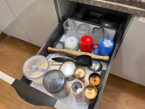 a drawer filled with pots and pans and a knife at Quantum stay 1 BHK couples family corporate in Noida