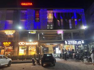 a car parked in front of a building at night at Quantum stay 1 BHK couples family corporate in Noida