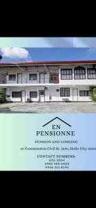 a white building with a sign in front of it at En Pensionne, Lodging in Iloilo City