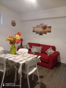 a living room with a red couch and a table at S1 Home Sila in Camigliatello Silano