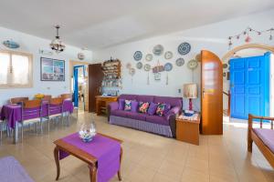 a living room with a purple couch and a table at Villa Lia Panorama in Pefki Rhodes