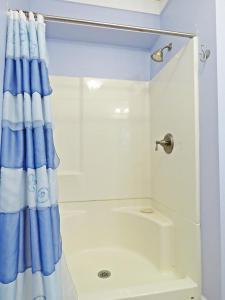 a shower with a blue shower curtain in a bathroom at Lily Pad Lake Views in Cape May Point +22 photos