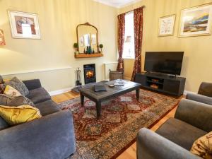 a living room with a couch and a coffee table at Clocktower - Culzean Castle in Maybole