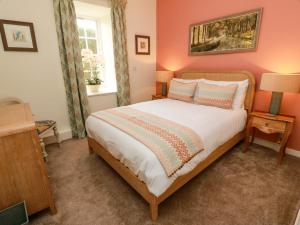 a bedroom with a bed and two lamps and a window at Clocktower - Culzean Castle in Maybole