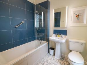 a bathroom with a tub and a sink and a toilet at Clocktower - Culzean Castle in Maybole +52 photos