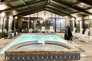 a large swimming pool with chairs and a table at Quality Inn Byron - Warner Robins in Byron