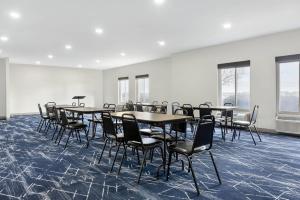 a conference room with tables and chairs and windows at Comfort Inn & Suites Springfield in Springfield +33 photos