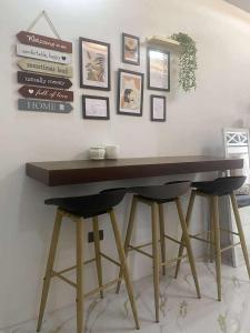 a wooden table with two stools in a room at Balay Buenavista in Magdalena