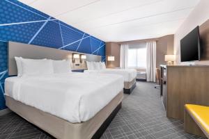 a hotel room with two beds and a flat screen tv at Comfort Inn Eagan Minneapolis - St Paul South in Eagan +36 photos