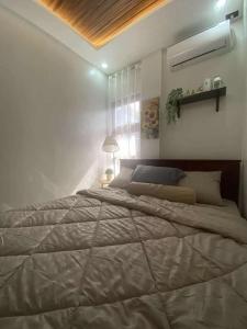 a bedroom with a large bed in a room at Balay Buenavista in Magdalena +2 photos