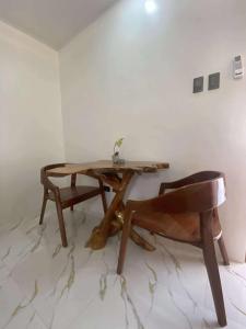 a wooden table and a chair in a room at Balay Buenavista in Magdalena