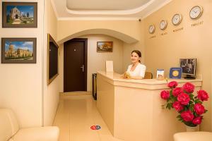 a woman sitting at a counter in a waiting room at Rustaveli Palace in Tbilisi City