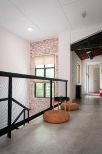 a room with a table and benches in a building at Aceh Suites by Aayu - 1 min walk to Armenian St in George Town