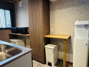 a kitchen with a sink and a refrigerator and a counter at HAOSTAY Eirin in Fujikawaguchiko