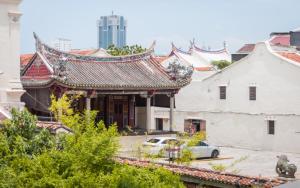a car parked in front of a building with a roof at Aceh Suites by Aayu - 1 min walk to Armenian St in George Town
