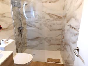 a bathroom with a shower and a toilet at Zen House in Maspalomas +6 photos