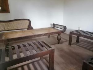 two wooden benches sitting in a room at Swastha Retreat in Polgahawila