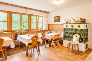 a restaurant with tables and chairs in a room at Biobauernhof Windbachgut in Eben im Pongau