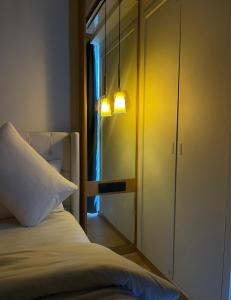 a bedroom with a bed and a cabinet with a mirror at RARA HM Suites in Hulhumale