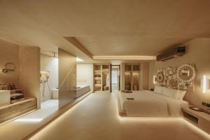 a large bedroom with a large bed and a bathroom at Café del Mar Phuket - Suite & Penthouse in Kamala Beach +55 photos