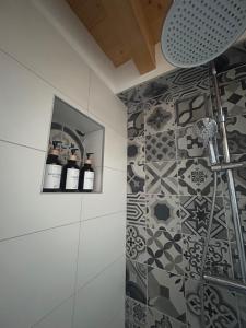 a bathroom with a shower with two bottles of wine at Casa Majagatt Holiday Home in Roveredo +7 photos