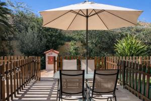 a table and chairs under an umbrella on a patio at Zen House in Maspalomas