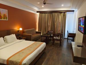 a hotel room with a bed and a living room at HOTEL SKY PARADISE in Iritti