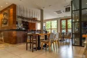 a restaurant with tables and chairs in a room at Hotel Boutique Las Hortensias in Pilar