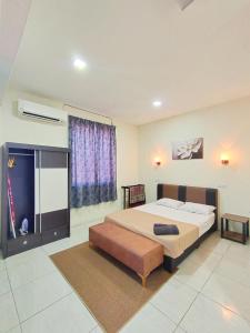 a bedroom with a large bed and a window at D'Aleena Inn Kodiang in Kodiang