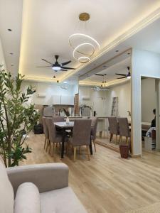a living room with a dining table and chairs at MyShelter Melaka in Kelebang Besar