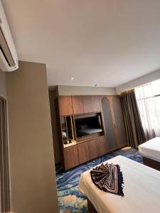 a hotel room with two beds and a television at Brisdale International Kuala Lumpur in Kuala Lumpur +42 photos