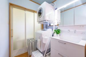 a bathroom with a sink and a washing machine at Nagoya Homestay in Nagoya +52 photos