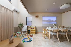 a dining room with a table and chairs and a classroom at Nagoya Homestay in Nagoya