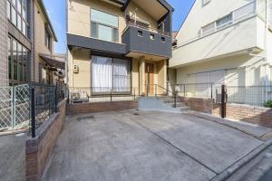 an empty driveway in front of a house at Nagoya Homestay in Nagoya