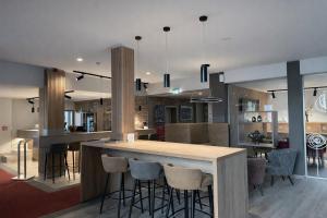 a kitchen with a bar with stools at Konsum Berghotel Oberhof in Oberhof