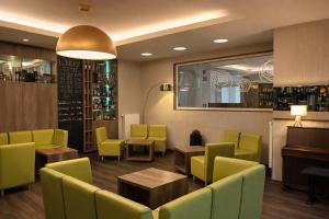 a restaurant with yellow and green chairs and tables at Konsum Berghotel Oberhof in Oberhof +93 photos