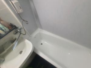 a small bathroom with a sink and a toilet at Sunset Bird Watcher Apartament in Visaginas