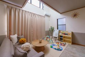 a living room with a couch and a table at Nagoya Homestay in Nagoya