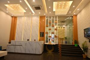 a lobby of a store with a counter and stairs at Hotel Sai Paradise in Lucknow