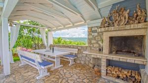 a patio with a table and a fireplace at Villa Estate 2 by Villas Guide in Kornić