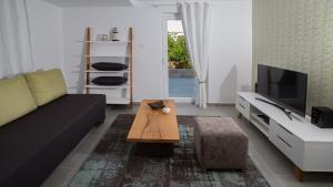 a living room with a couch and a coffee table at Villa Estate 2 by Villas Guide in Kornić