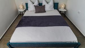 a large bed in a room with two tables at Villa Estate 2 by Villas Guide in Kornić +9 photos