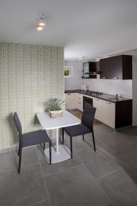 a kitchen with a white table and two chairs at Villa Estate 2 by Villas Guide in Kornić