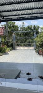 a patio with a gate and a person in the background at Vùng ven Homestay in Cho Lach